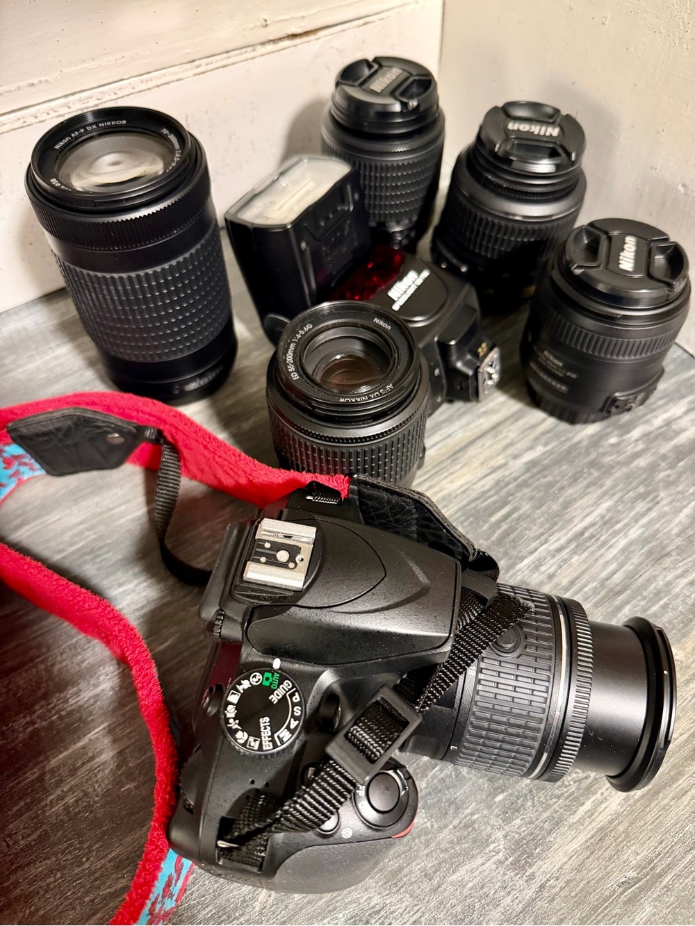 Nikon Camera Kit with Black Lenses and Red Strap